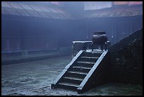 Urn and stairs in courtyard of Xiangfeng temple in fog. Emei Shan, Sichuan, China