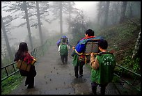 Weathy pilgrim carried on a chair. Emei Shan, Sichuan, China (color)