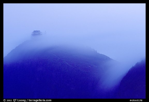 Fog sweaps over Wanfo Ding (Ten Thousand Buddhas Summit) at dusk. Emei Shan, Sichuan, China