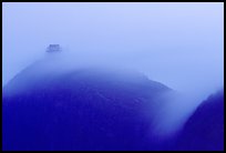 Fog sweaps over Wanfo Ding (Ten Thousand Buddhas Summit) at dusk. Emei Shan, Sichuan, China