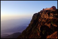 Jinding Si temple perched on a precipituous cliff at sunrise. Emei Shan, Sichuan, China