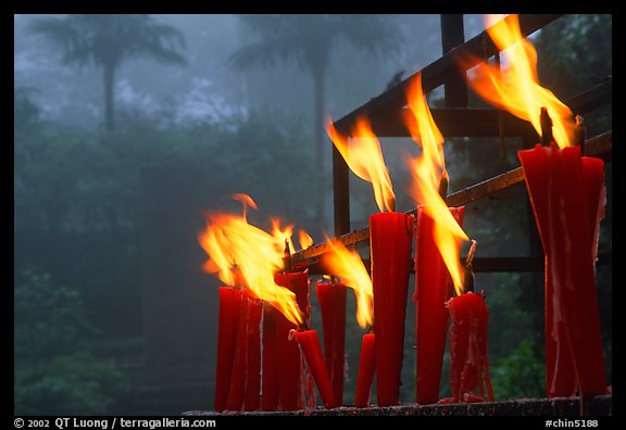 Candles burning with foggy trees in the background, Wannian Si. Emei Shan, Sichuan, China