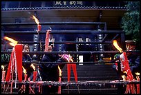 Pilgrims lighting incense sticks with Wannian Si temple in the background. Emei Shan, Sichuan, China ( color)