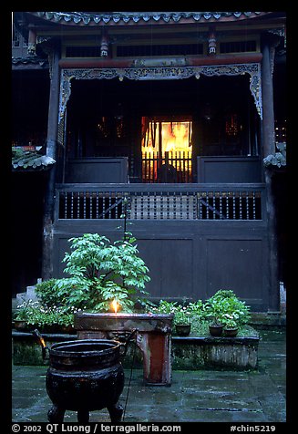 Buddha image seen from rainy courtyard of Hongchunping temple. Emei Shan, Sichuan, China