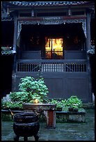 Buddha image seen from rainy courtyard of Hongchunping temple. Emei Shan, Sichuan, China