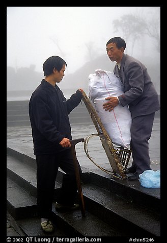 Porter getting ready to carry a heavy load on a back frame. Emei Shan, Sichuan, China (color)