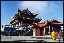 Monk walking in front of Jinding Si temple. Emei Shan, Sichuan, China