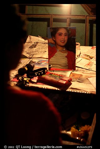 Sichuan opera actress checks her hair in a mirror. Chengdu, Sichuan, China (color)