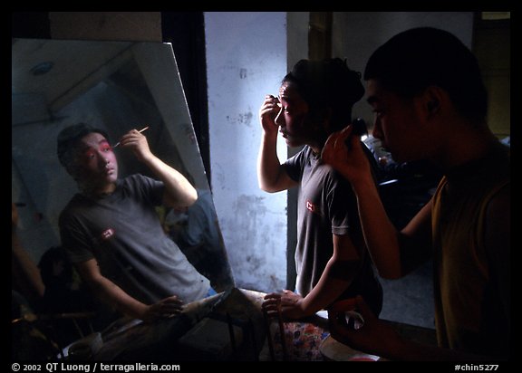 Two Sichuan opera actors apply makup before the performance. Chengdu, Sichuan, China (color)