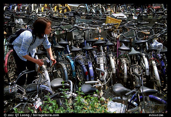 Retriving a bike in the bicycle parking lot. Chengdu, Sichuan, China (color)
