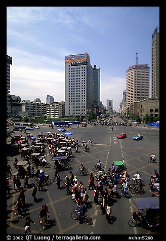 Pedestrians and bicyclists cross a major avenue. Chengdu, Sichuan, China (color)