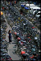 Woman walking in a bicycle parking lot. Chengdu, Sichuan, China