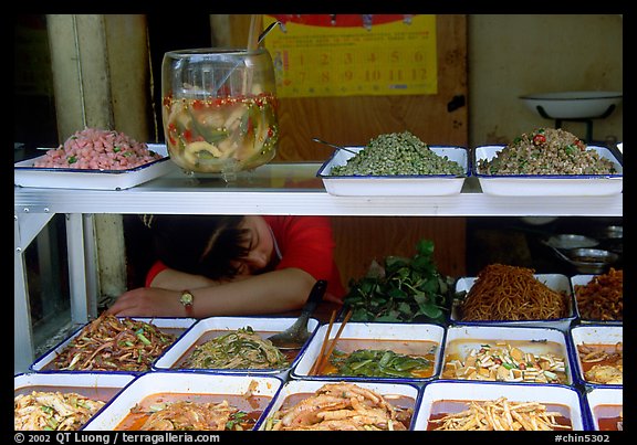 Vendor taking a nap at a food stall.. Chengdu, Sichuan, China (color)
