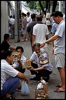 Peddling birds on the street. Guangzhou, Guangdong, China