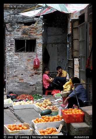 Fruit vendors in a narrow alley. Guangzhou, Guangdong, China (color)