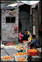 Fruit vendors in a narrow alley. Guangzhou, Guangdong, China