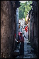 Man using stream water in alley. Hongcun Village, Anhui, China