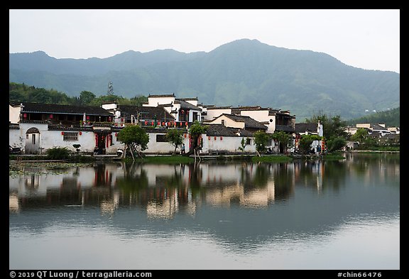 Hongcun village and mountains reflected in South Lake. Hongcun Village, Anhui, China (color)