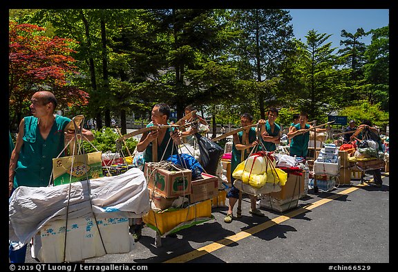 Porters resting heavy loads on pole. Huangshan Mountain, China (color)