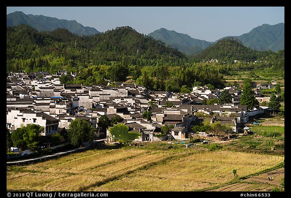 Field workers and village from above. Xidi Village, Anhui, China (color)