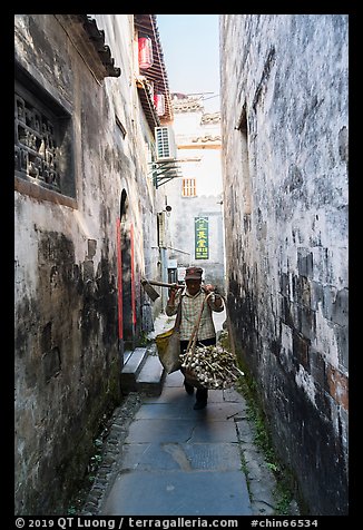 Woman returning from harvest. Xidi Village, Anhui, China