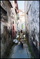 Woman returning from harvest. Xidi Village, Anhui, China