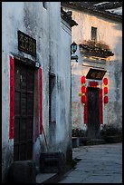 Morning light streaming on walls with lanterns. Xidi Village, Anhui, China