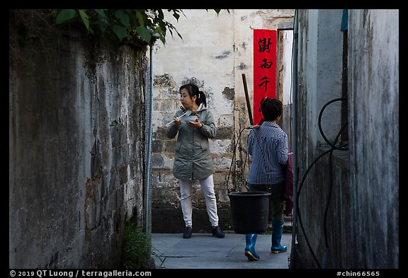 Two women in alley. Xidi Village, Anhui, China (color)
