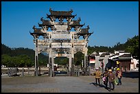 Villagers heading towrds fields, and Hu Wenguang Memorial Arch. Xidi Village, Anhui, China