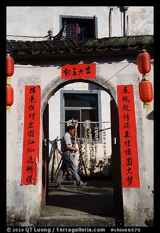 Man with garlic braids hung to dry. Xidi Village, Anhui, China (color)