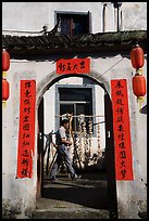 Man with garlic braids hung to dry. Xidi Village, Anhui, China