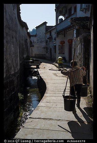 Woman carrying buckets. Xidi Village, Anhui, China (color)