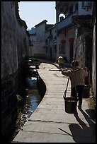 Woman carrying buckets. Xidi Village, Anhui, China ( color)
