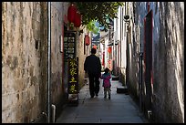 Father and daughter walking in alley. Xidi Village, Anhui, China