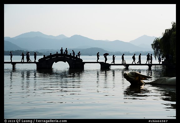 People walking on Yongjin Bridge, West Lake. Hangzhou, China (color)