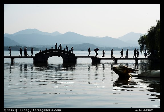 People walking on Yongjin Bridge, West Lake. Hangzhou, China