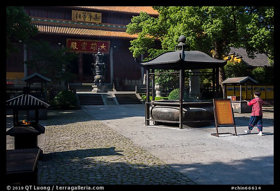 Woman offering incense, Jingci Temple. Hangzhou, China