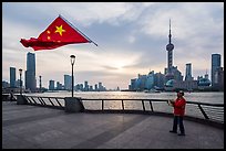 Man flying kite with Chinese flag attached on line, the Bund. Shanghai, China ( color)