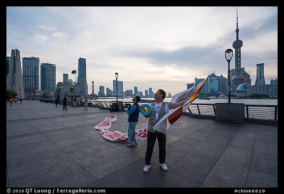 Men preparing to fly kites. Shanghai, China (color)