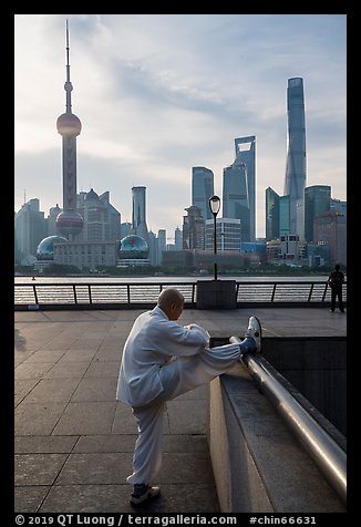 Man stretching and Oriental Pearl Tower, the Bund. Shanghai, China (color)