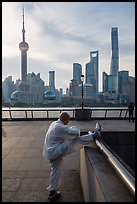 Man stretching and Oriental Pearl Tower, the Bund. Shanghai, China ( color)