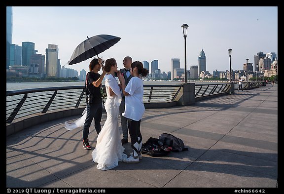 Bride and groom setting up for photos, the Bund. Shanghai, China (color)