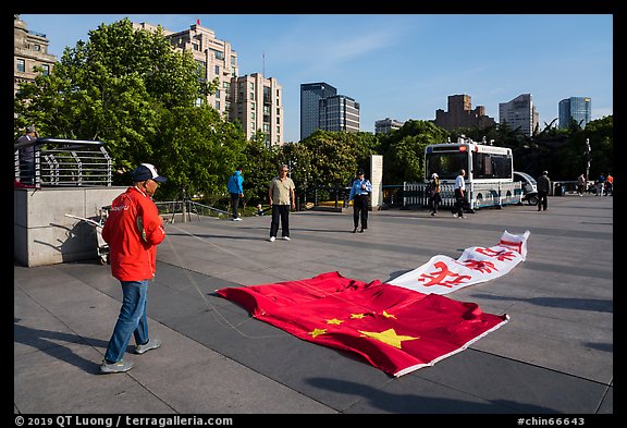 Man with kite on the ground, the Bund. Shanghai, China (color)