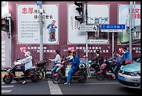 Motercycle riders waiting at trafic light. Shanghai, China ( color)