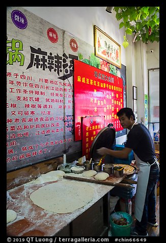 Man preparing breakfast pancakes. Shanghai, China (color)