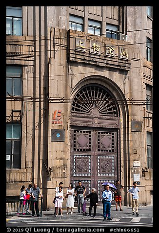 People standing in front of historic bank gate. Shanghai, China (color)