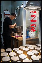 Man poking fighting crickets with stick. Shanghai, China ( color)
