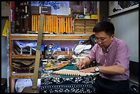 Man working on fan. Shanghai, China ( color)