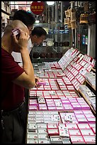 Man listening at insect. Shanghai, China ( color)