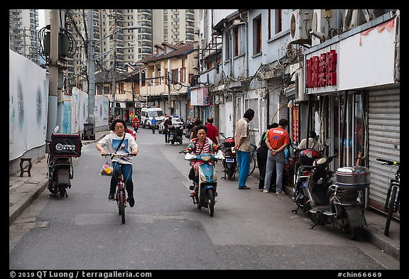 Old Street lined with old buidings and modern towers. Shanghai, China (color)